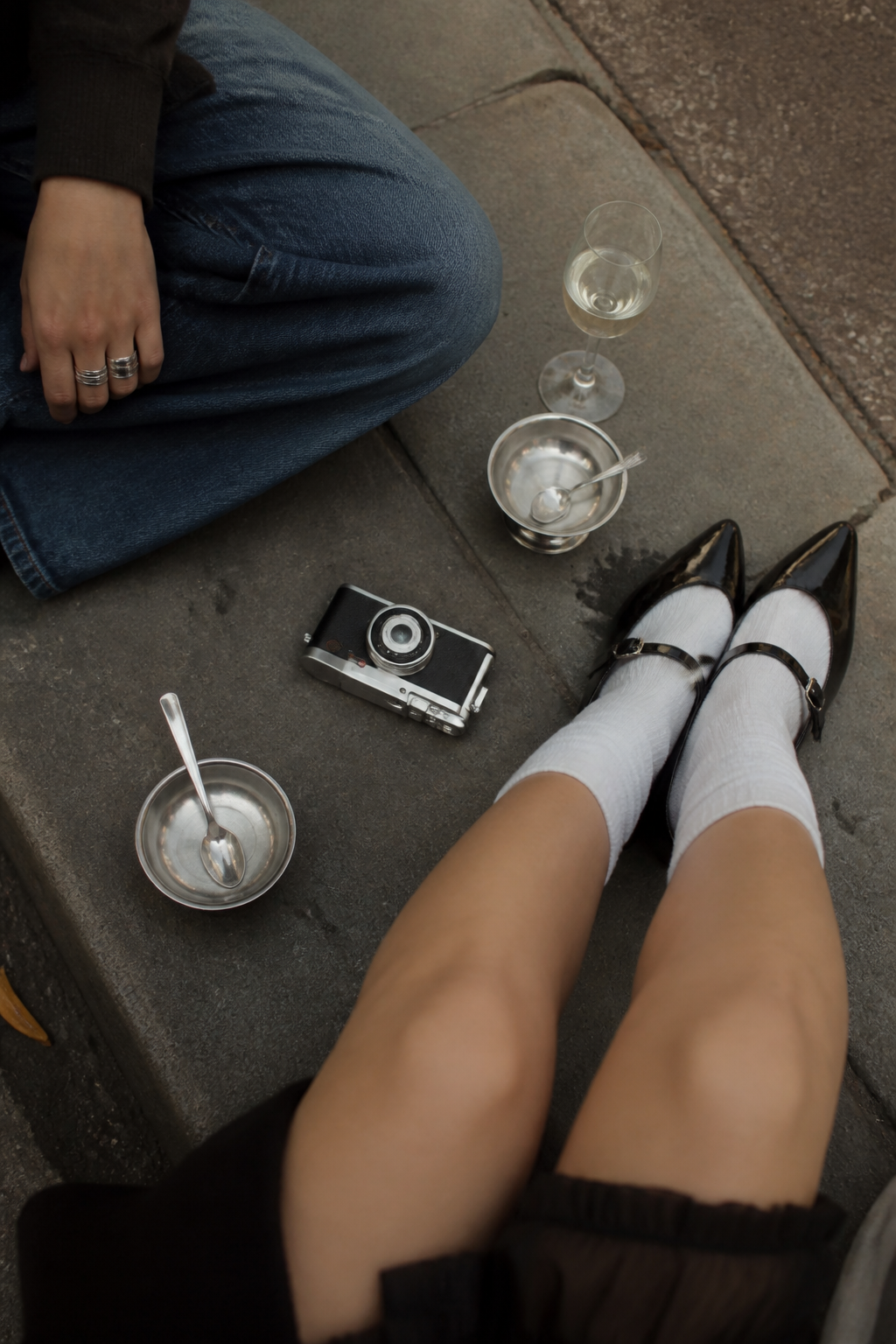 Friends with a compact camera on a city curb